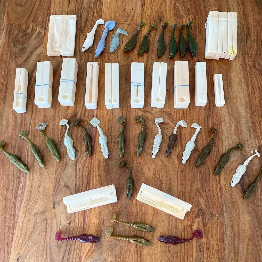 Collection of prototype molds and soft plastic lures from the iteration process